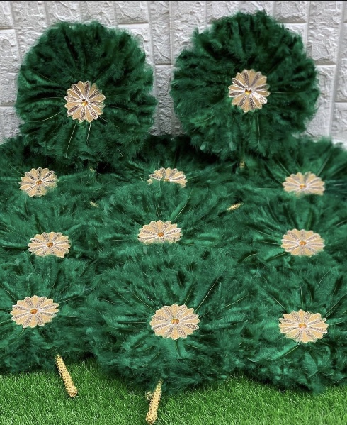Emerald green matching hand fans arranged as a set